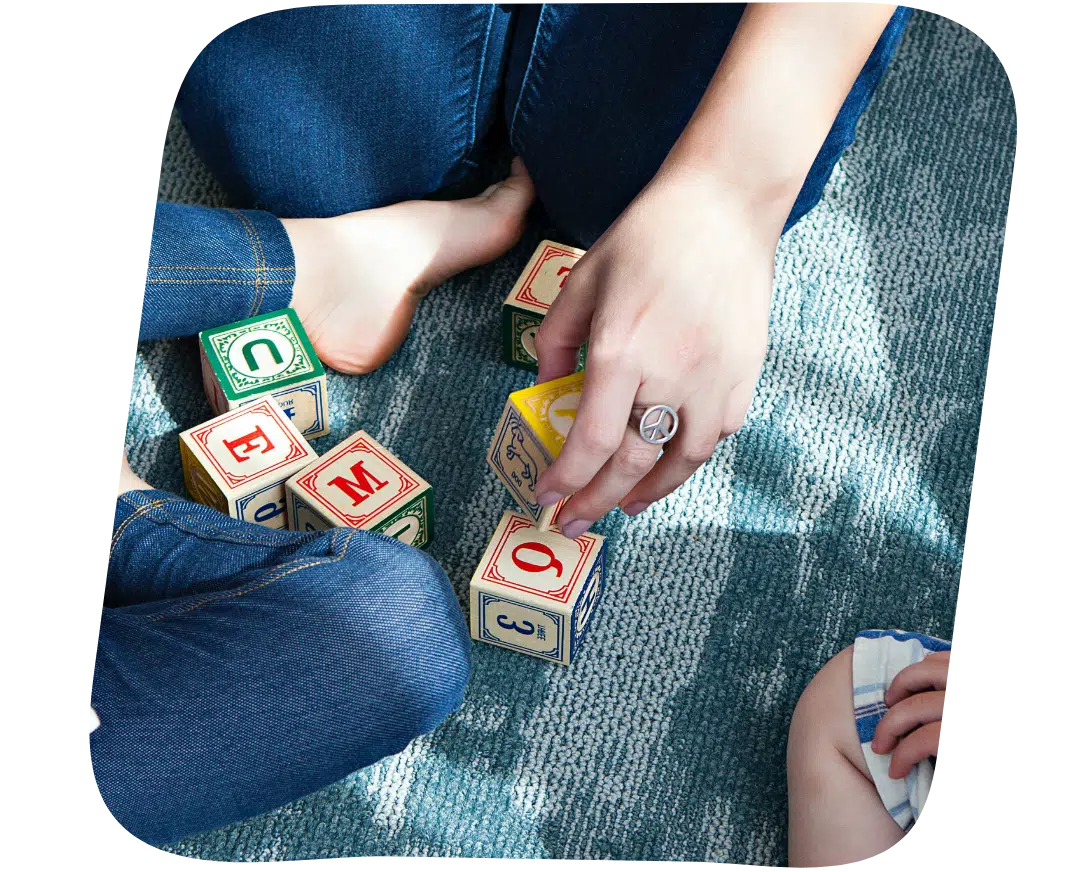 A child and woman with wooden blocks