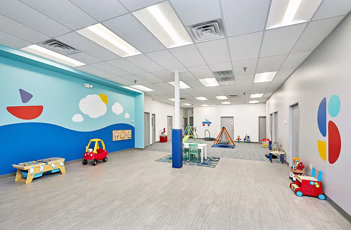 autism-treatment-center-clinton-iowa-aba-therapy-52732-stride-centers (2) View of interior open space with toys, a table, and multiple doors at the Stride Autism Center near Clinton, Iowa.