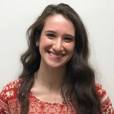 Danielle-Markowitz,-BCBA Headshot of a woman with wavy hair, looking straight at the camera while smiling.