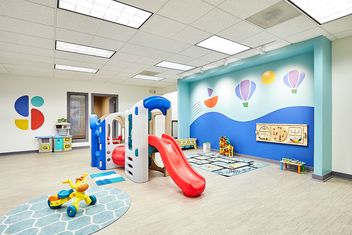 View of interior open space with toys, door and interior window at the Stride Autism Center near Atkins, Iowa.