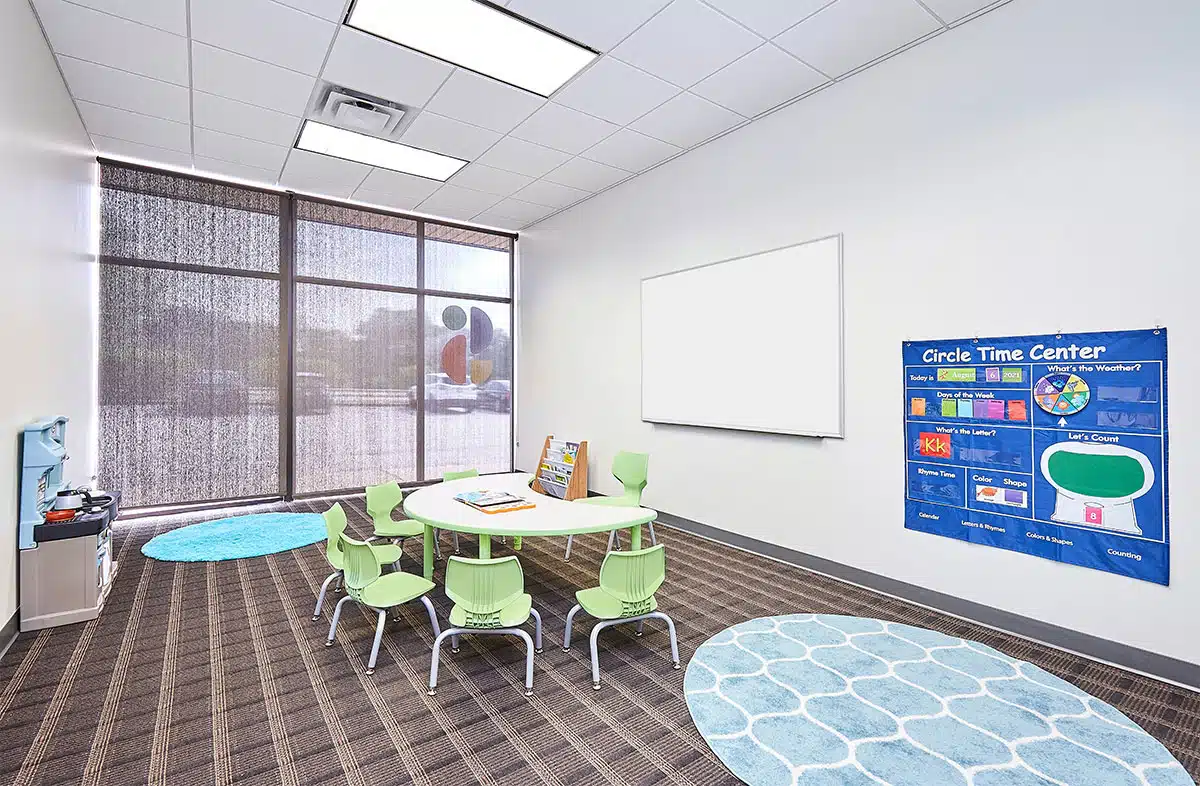 Classroom with whiteboard, table and chairs where children with autism learn skills during their full-day ABA program near Princeton, Davenport, Iowa.