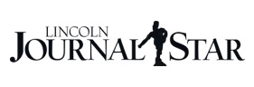 Photo of a text that reads "Lincoln Journal Star." A logo is present between the words Journal and Star.