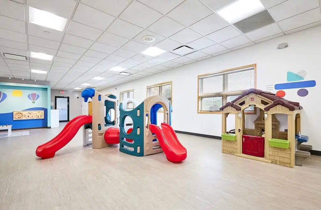 A dedicated Stride Autism Centers&reg; therapist guides a young child during a school readiness ABA therapy activity.