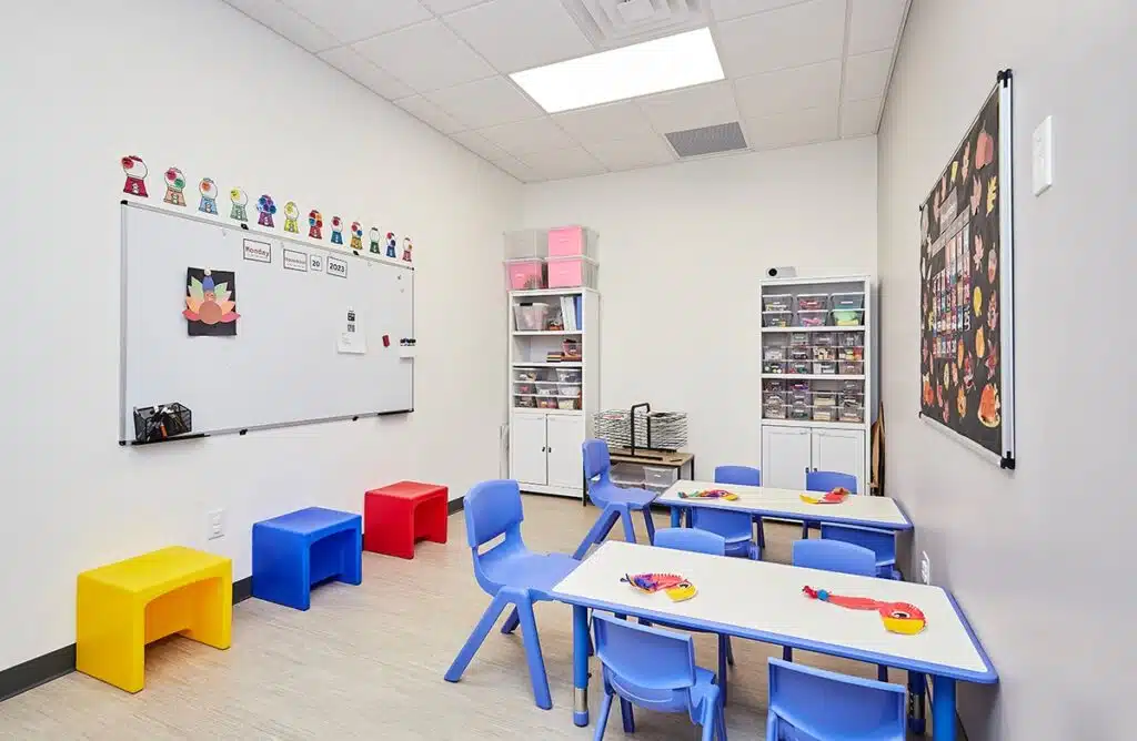 An interior view of the Stride Autism Center in West Omaha, Nebraska, featuring a modern and bright ABA therapy room.