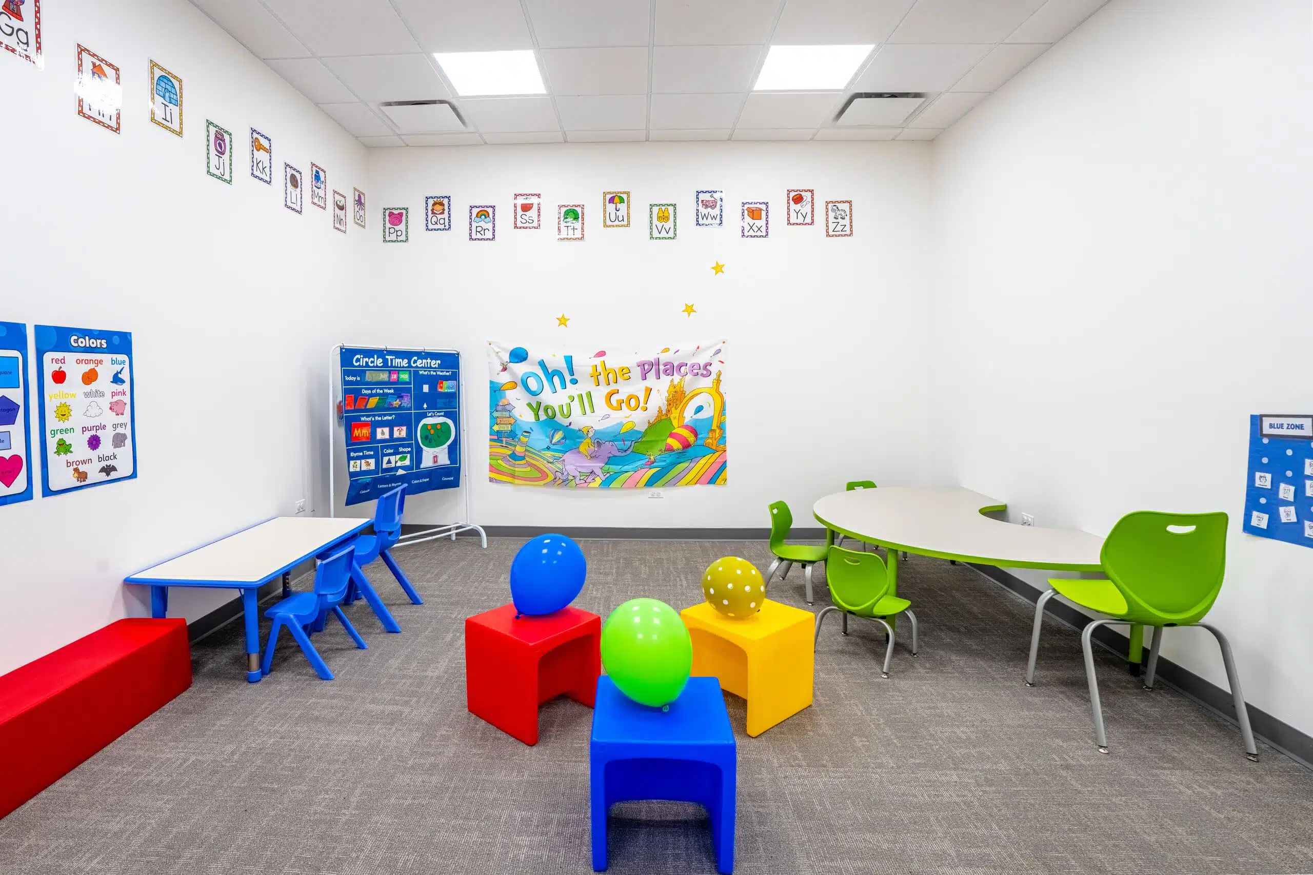 A colorful and bright therapy room at Stride Autism Centers&reg; in Oak Park, IL, featuring kid-sized tables and some toys.
